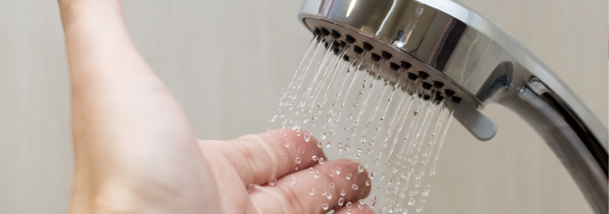 hand under shower spray to test temperature