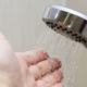 hand under shower spray to test temperature