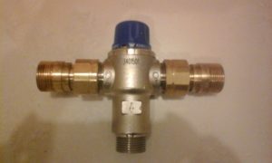Look for a tempering valve in your hot water cupboard, attached to the cylinder's pipework.